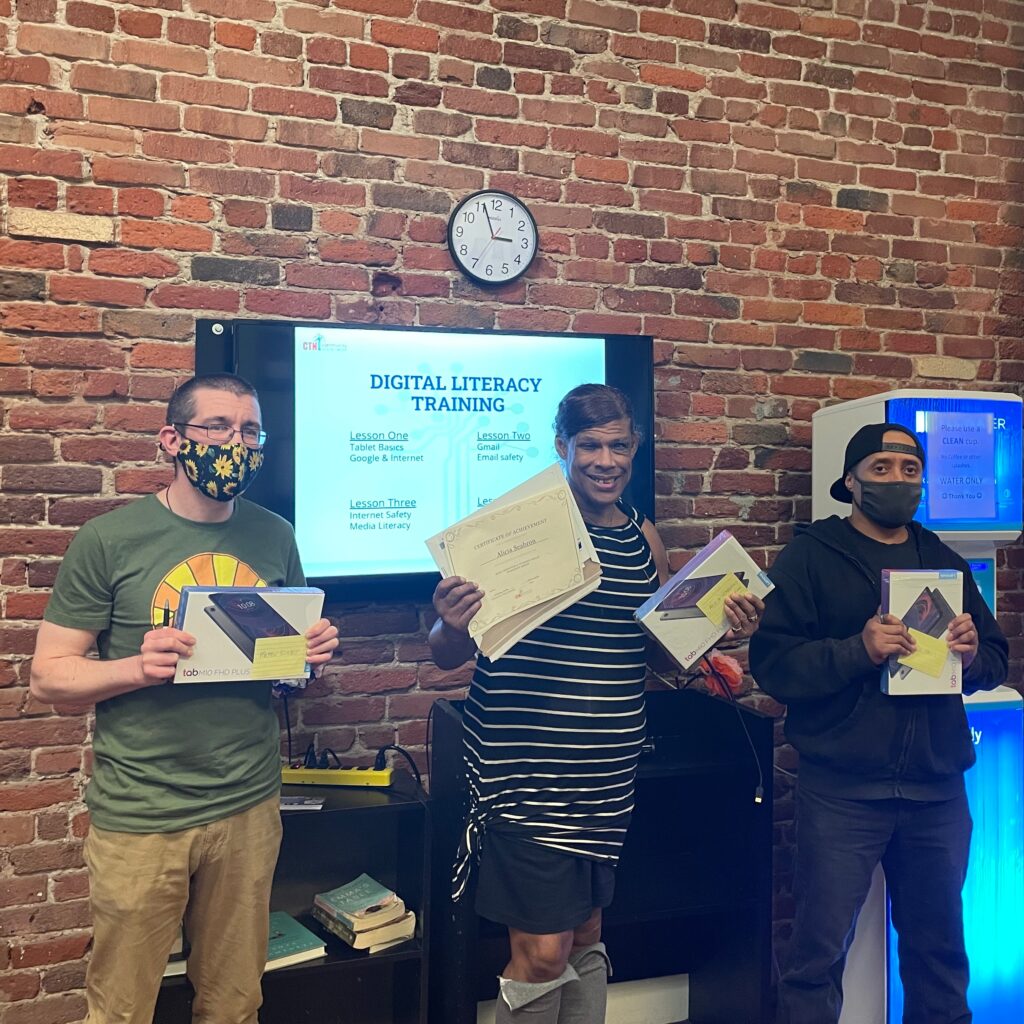 3 people holding certificates and boxed tablets